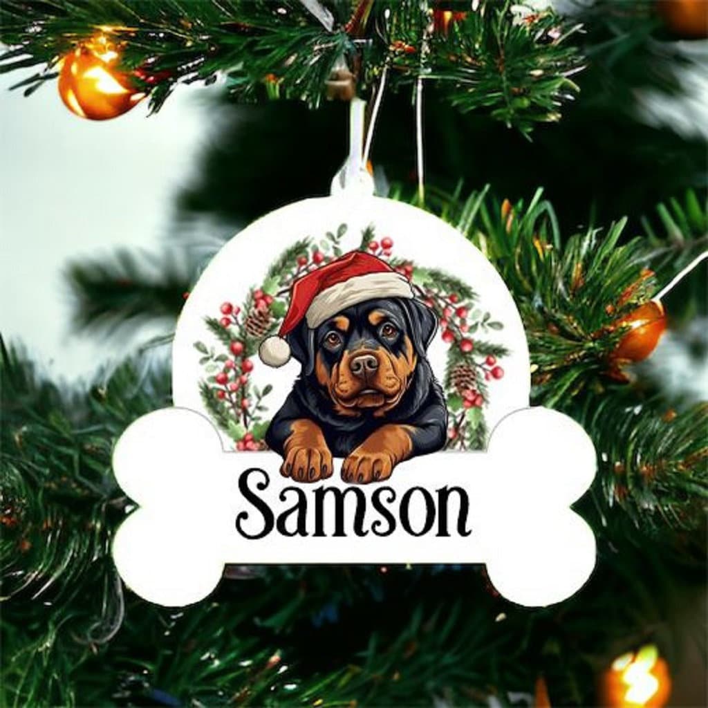 Personalised Christmas Bauble Of Rottweiler sat in a wreath, choice of Ribbon Colour