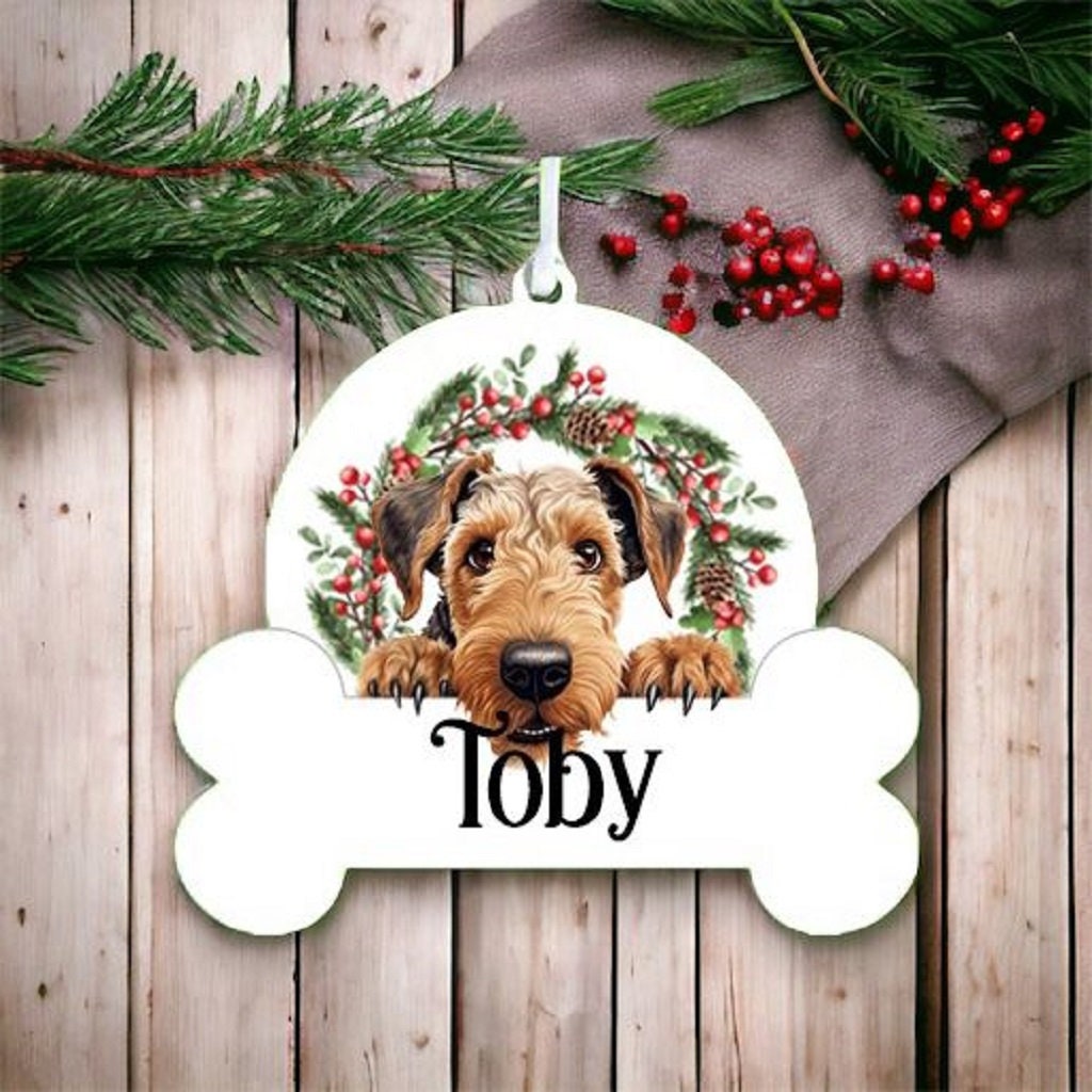 Personalised Christmas Bauble with Airedale Terrier sat in a wreath